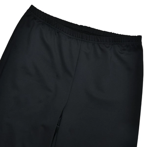 Detail of elastic waistband on black flared trousers with high-quality fabric texture