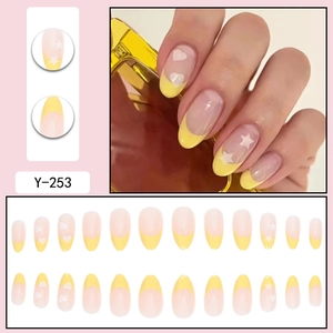 French yellow almond press-on nails with white stars and hearts patterns