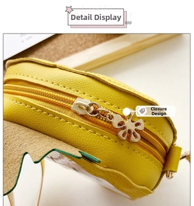 Close-up of yellow leather pineapple bag featuring a floral metal zipper pull detail