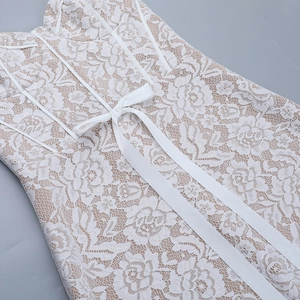 Detail of white floral embroidery dress with corset boning and a large satin bow sash