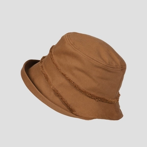 Close-up of brown cotton canvas sun hat featuring vintage raw fringe edge detail
