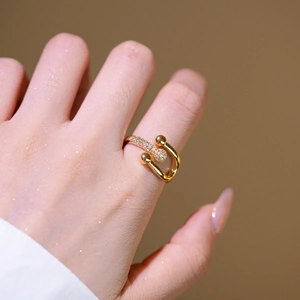 Minimalist gold-plated horseshoe open ring with micro-pave cubic zirconia on hand
