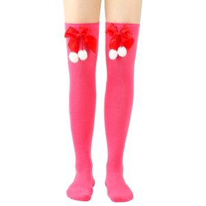 Detail of rose pink over-the-knee socks with red satin bow and white pom-poms accents