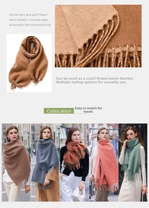 Detailed view of the soft knitted texture and long fringe edges on this versatile scarf