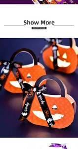 Detail of Halloween pumpkin gift bag with orange polka dots and black branded ribbons