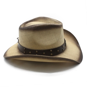 Classic straw cowboy hat with burnt edges and studded leather band on white background