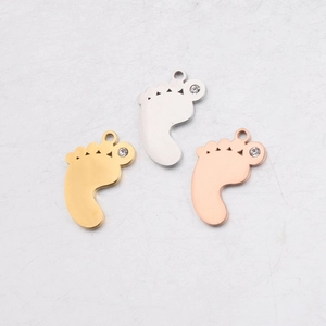 Polished stainless steel baby feet pendants with rhinestones in gold, silver, and rose gold