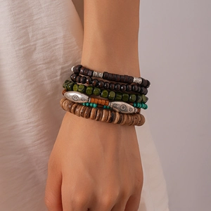 Detail of bohemian six-piece set with wooden beads and engraved sun pattern charms