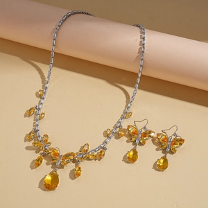 Vintage necklace and earrings set with yellow crystals and teardrop butterfly design