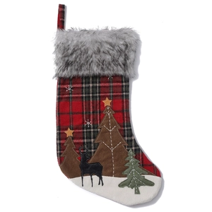 Plaid Christmas stocking with faux fur cuff featuring a reindeer and forest silhouette
