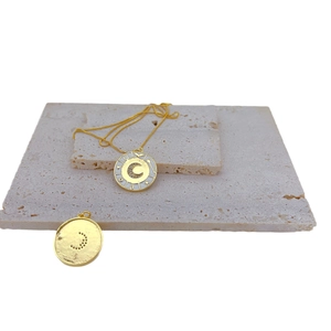 Gold plated moon and star pendant necklace with white enamel inlay on stone plates