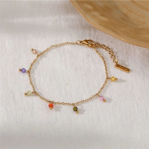 Golden stainless steel chain bracelet featuring delicate colorful beads and lobster clasp