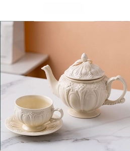 British style embossed ceramic tea set with teapot and cup on marble surface