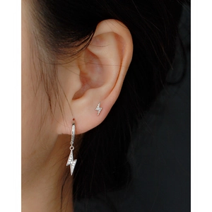 Minimalist s925 silver lightning bolt stud earrings with crystals worn by a model