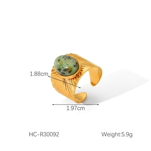 Detail view of gold stainless steel ring with green natural stone and size measurements