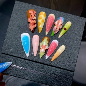 Detailed view of 3D floral press-on nails with vibrant gradient and water drop texture