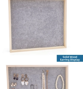 Wall-mounted wood jewelry organizer with grey velvet panel for earrings and necklaces