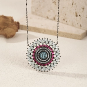 S925 sterling silver mandala necklace with colorful crystals on a beige stone surface