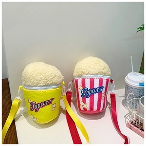 Detail of cute popcorn-shaped plush shoulder bags in yellow and red striped styles