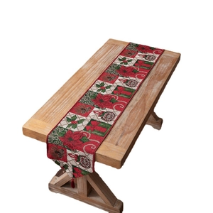 Christmas snowman table runner with red and green floral patterns on wooden table