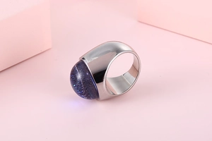 Detail of silver stainless steel ring featuring a dark blue stardust glass cabochon