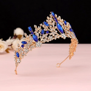 Detail of baroque gold crown with deep blue crystals and rhinestones for bridal hairstyle