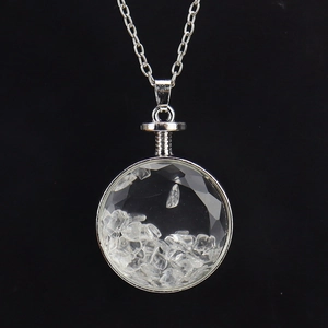 Detailed macro view of a silver circular glass locket filled with natural white crystals