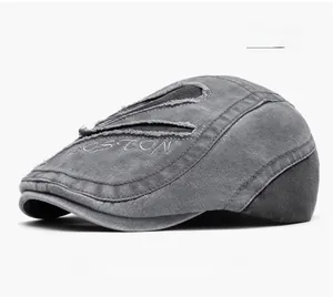 Close-up of grey vintage newsboy cap featuring BOSTON embroidery and distressed fabric detail