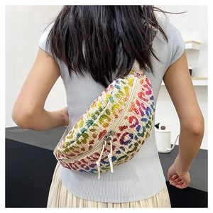 Detail of straw woven fanny pack with rainbow leopard print worn by model from behind