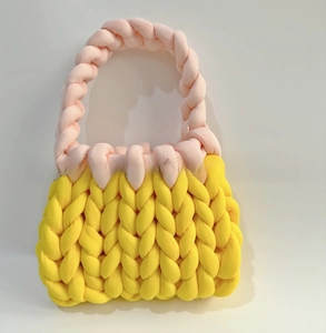 Close-up of chunky knit bag showing yellow and pink woven texture in thick cotton cord