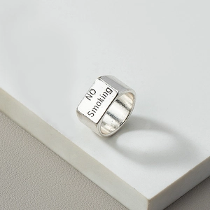 Silver metal wide band ring with NO Smoking engraving on a minimalist block