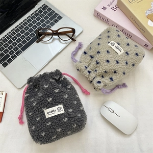 Detailed top view of soft fleece drawstring storage bags with polka dots and cloth labels
