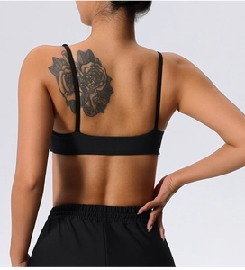 Detail of cross-back sports bra with fine rib texture and thin elastic straps