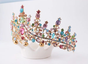 Macro detail of a golden bridal crown with colorful gems and multi-color crystal stones