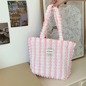 Detail of pink and white striped tote bag with bubble pleat texture and love label