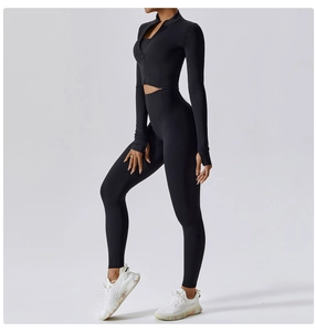 Side view of black yoga set featuring a long sleeve zip top and high waist leggings