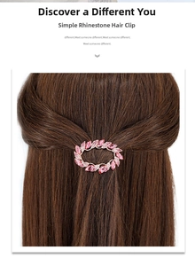 Detailed view of pink crystal spring hair clip worn on long brown hair for elegant styling