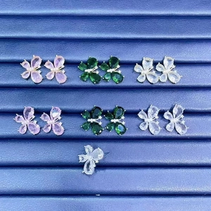 Elegant butterfly stud earrings with colorful zircon stones in a jewelry display tray