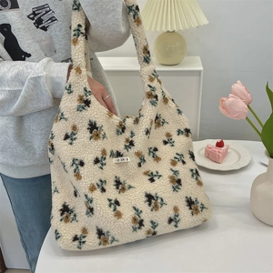 Detail of plush floral tote bag with soft sherpa texture and brand label