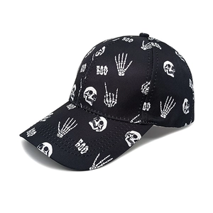 Detail of black baseball cap with white skull, skeleton hands, and BOO print design