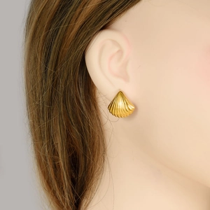Golden seashell stud earrings in 18k gold plated 304 stainless steel on model ear