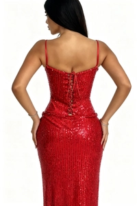 Detail of red sequin evening dress back featuring adjustable lace-up straps and silhouette