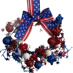 Patriotic USA Independence Day wreath with red white and blue stars and striped bow