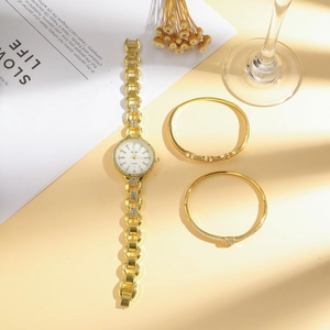 Luxury gold quartz watch with diamond-set chain and matching bracelets for women