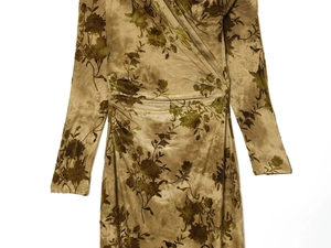 Detail of olive green velvet dress featuring vintage floral print and pleated waist design