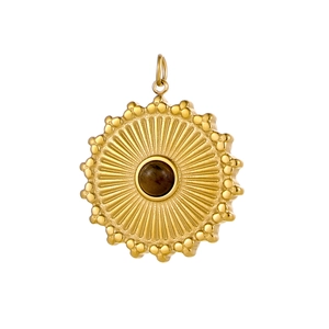 Detailed shot of golden sunburst pendant with dark natural stone and beaded edges