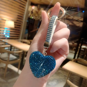 Detailed view of deep blue rhinestone heart keychain with gold-tone hardware and wristlet