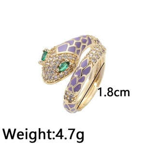 Adjustable gold snake ring with purple enamel, green gem eyes and pave crystals