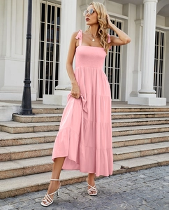 Detail of pink layered maxi dress featuring pleated bust and adjustable bow straps