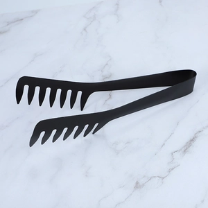 Close-up of black stainless steel pasta tongs with comb-like teeth on marble background